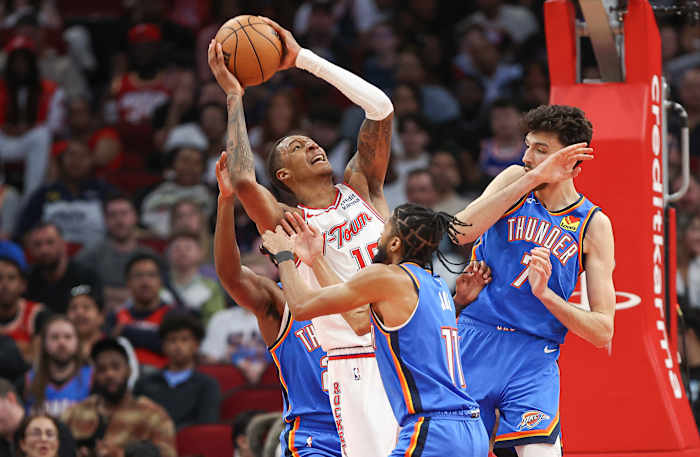 Rockets forward Jabari Smith Jr. (10) attempts to score a basket as Oklahoma City Thunder guard Isaiah Joe (11) defends during the third quarter at Toyota Center.